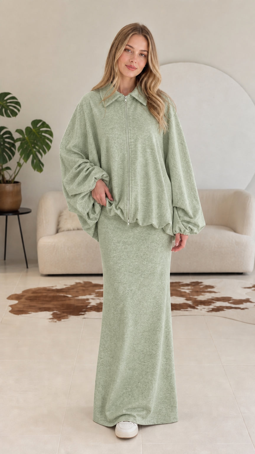 Model wearing sage green two-piece collared zip jacket and maxi skirt set