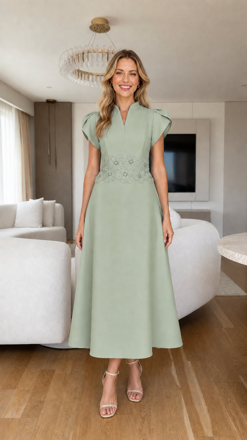 Front view of sage green tulip sleeve A-line midi dress with beaded waist