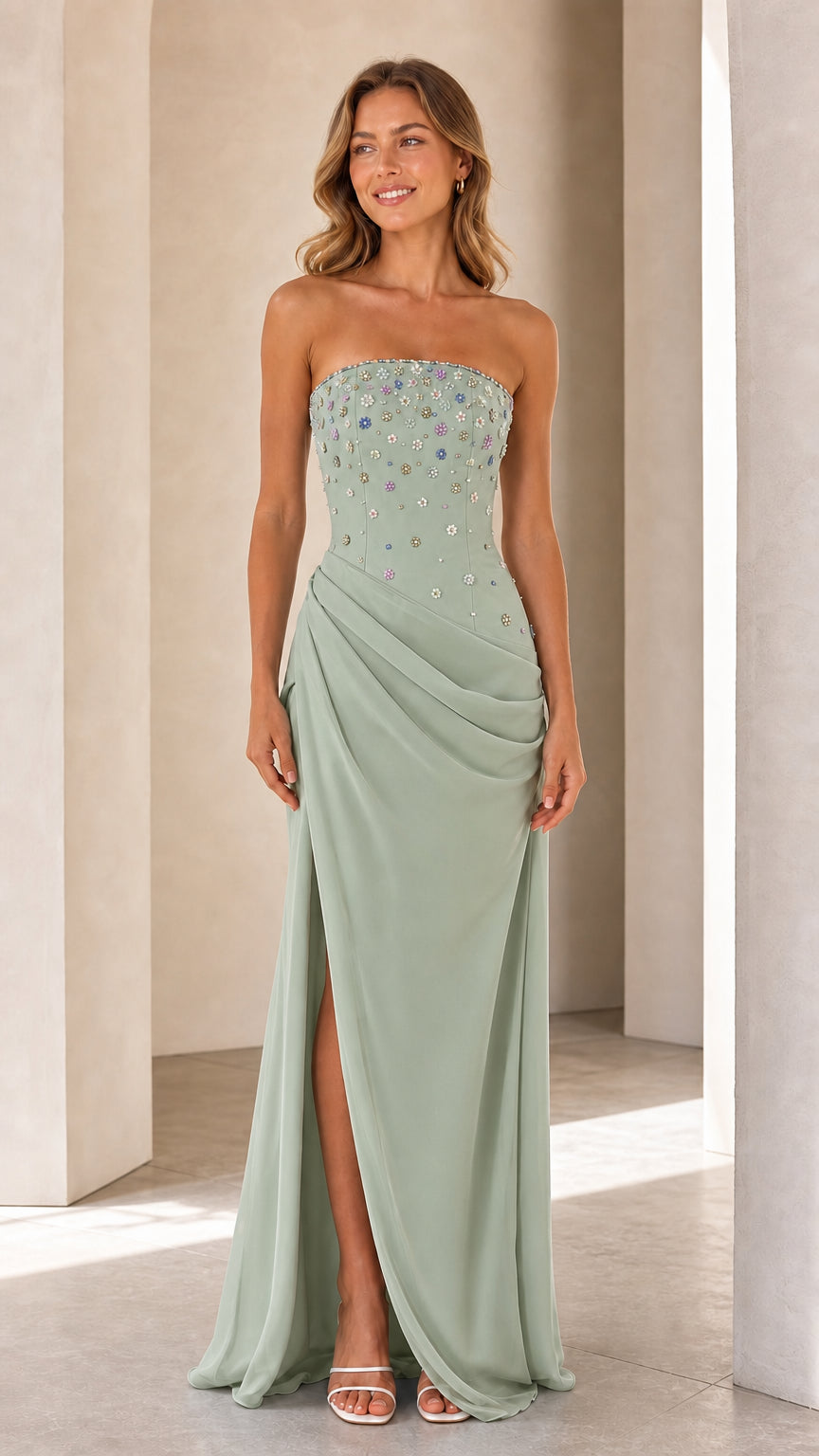 Model wearing Sage Green strapless beaded bodice formal gown with draped hip detail