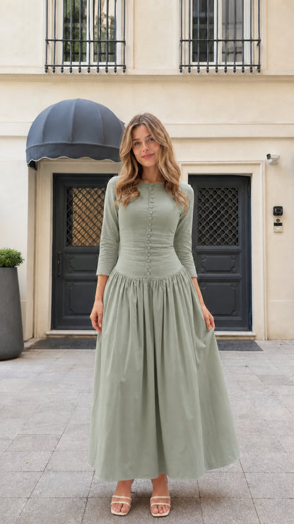 Model wearing sage green 3/4 sleeve pleated button-front maxi dress