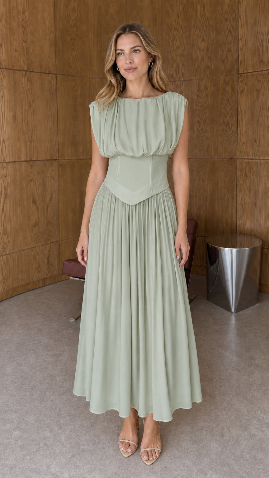 Full-length front view of sage green sleeveless basque waist pleated midi dress