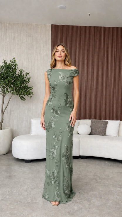 Model wearing sage green evening dress with floral appliques