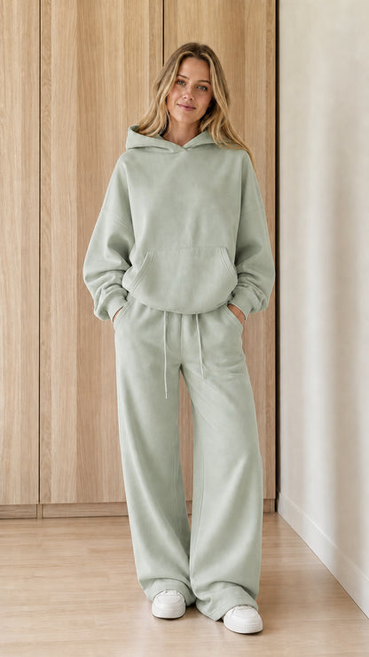 Model wearing a sage green women's hoodie and wide-leg sweatpants set