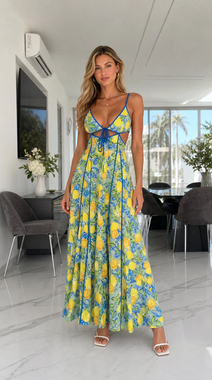 Model wearing bright yellow background lemon print cutout maxi dress