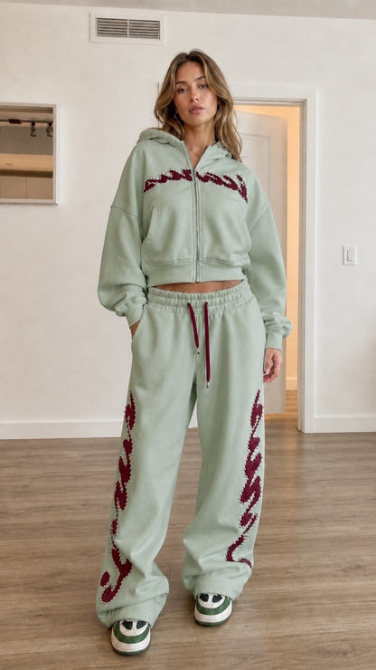 Model wearing sage green cropped hoodie and wide leg sweatpants set