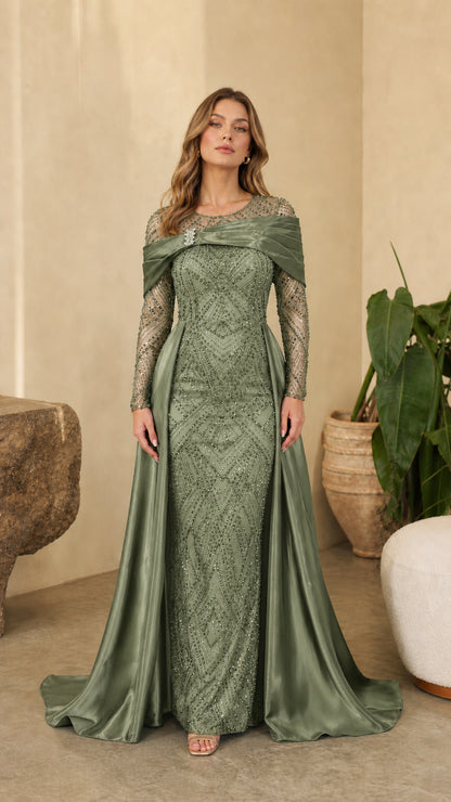 Full front view of model wearing Sage Green sequined long sleeve formal dress with draped satin overskirt