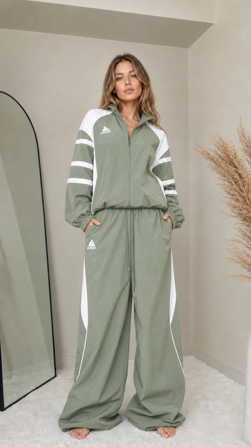 Front full-length view of woman wearing sage green colorblock tracksuit set