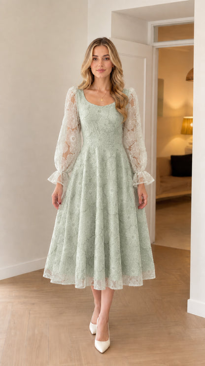 Model wearing sage green sheer sleeve embroidered midi evening dress