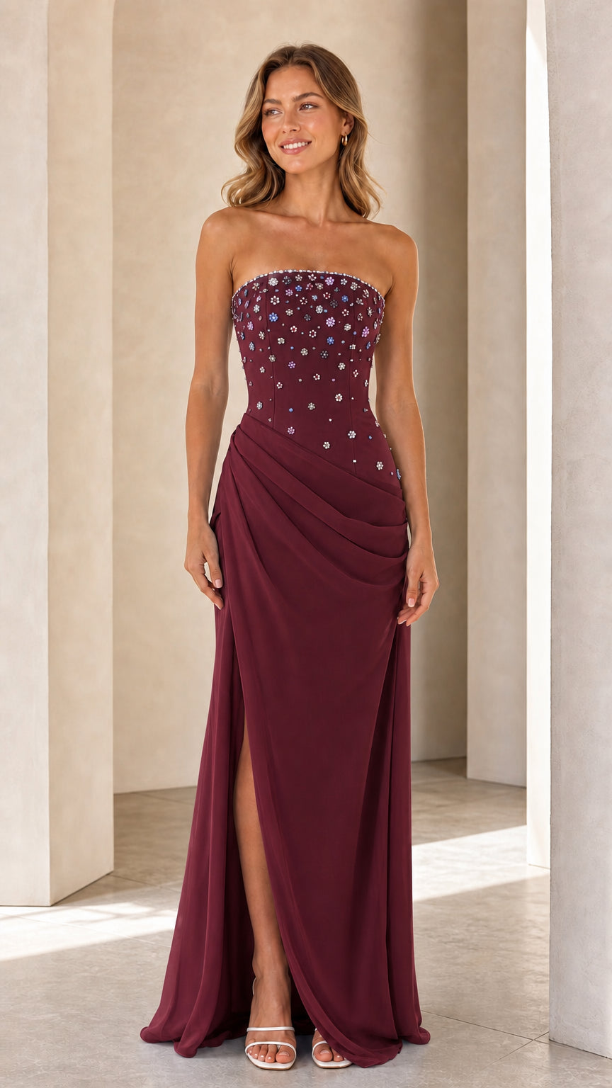 Model wearing Burgundy wine strapless beaded bodice evening gown with high leg slit