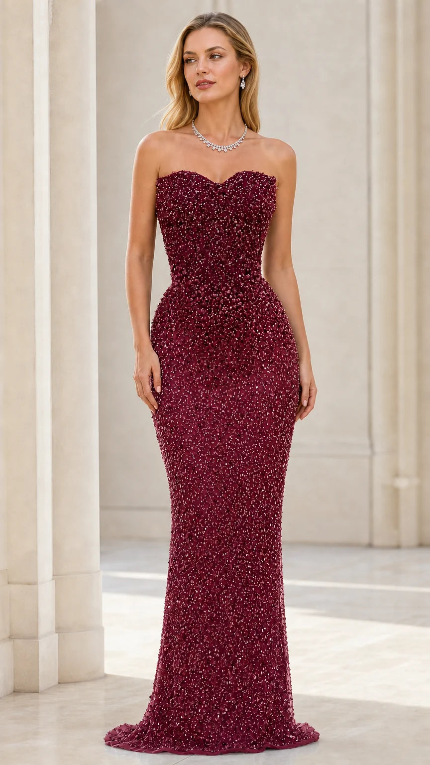 Front view of model wearing burgundy beaded strapless mermaid evening gown
