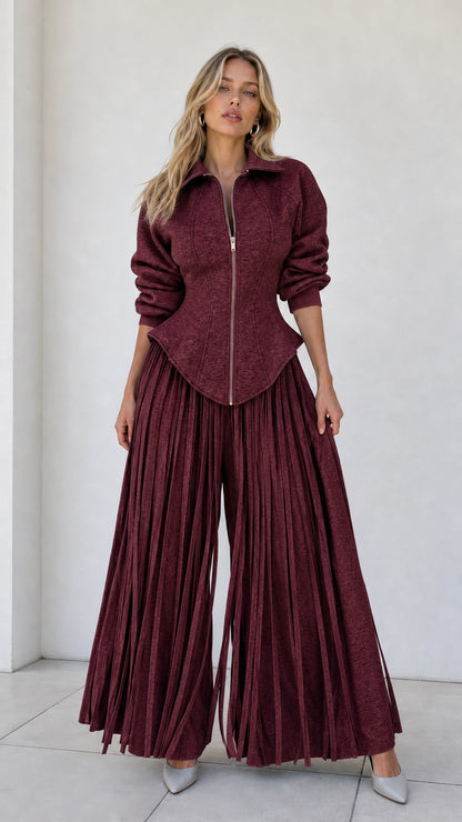 Model wearing burgundy wine red zip-front corset top and flowing pleated pants