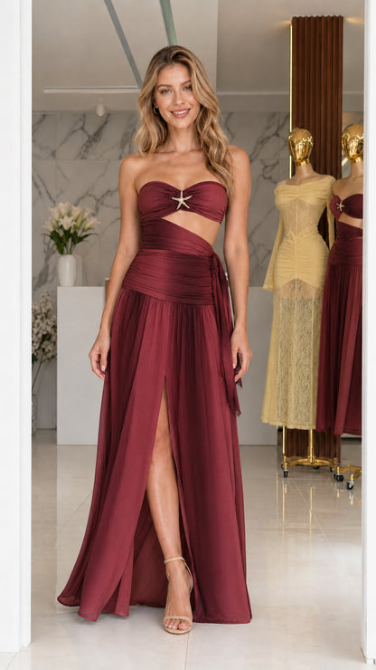 Model wearing burgundy strapless cutout long dress