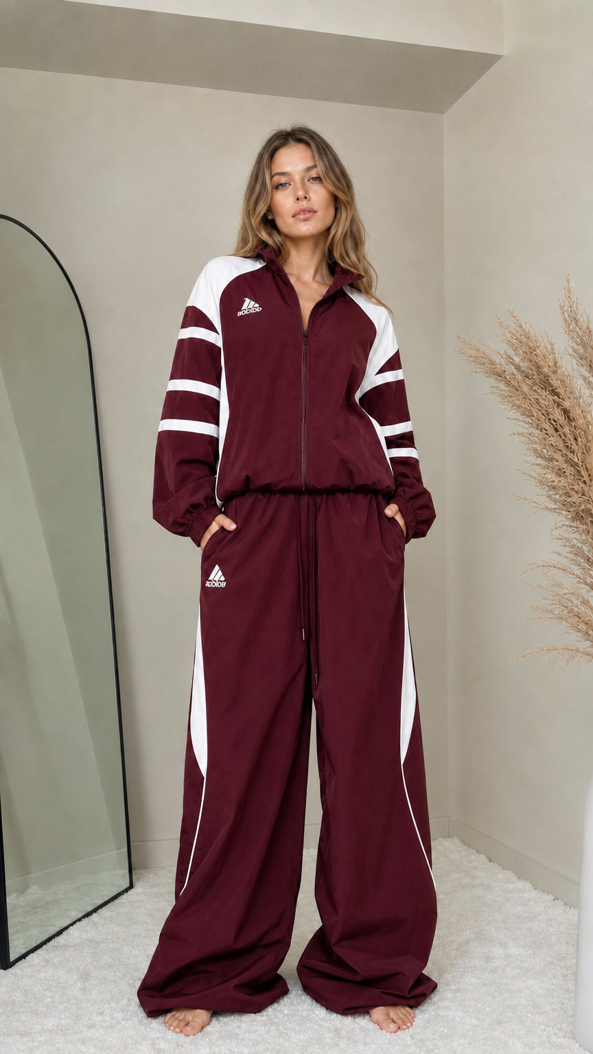 Front full-length view of woman wearing burgundy wine colorblock tracksuit set