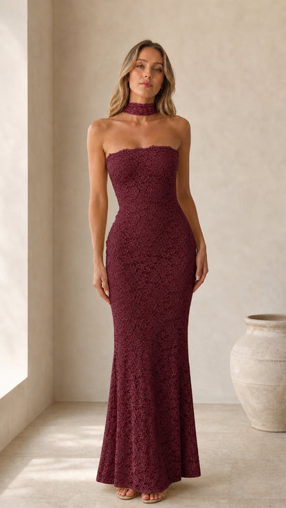 Front view of model wearing burgundy strapless lace maxi dress