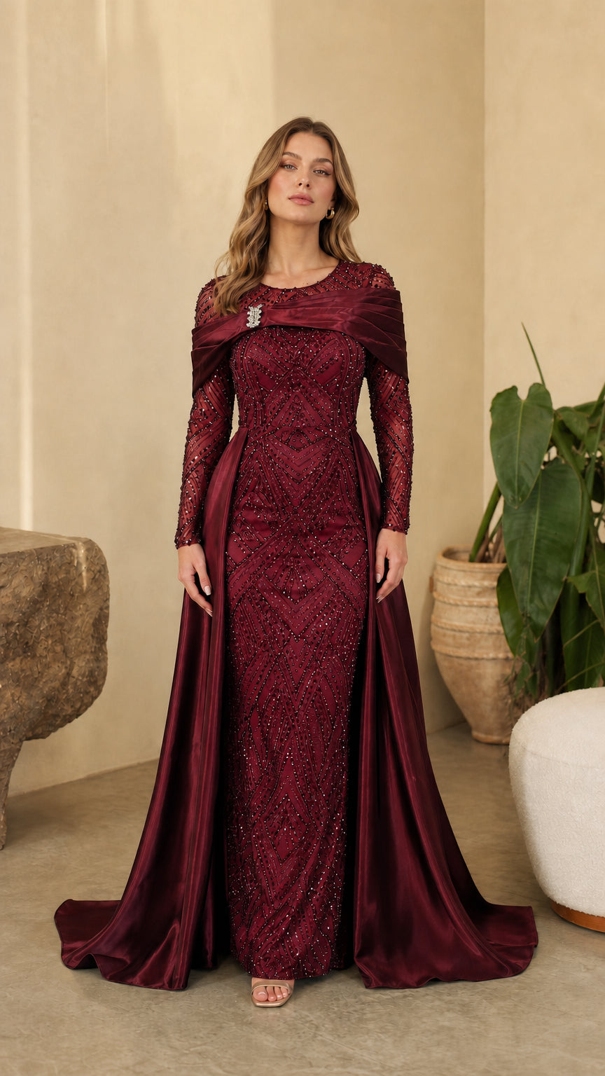 Full front view of model wearing Burgundy wine red sequin evening gown with draped satin train