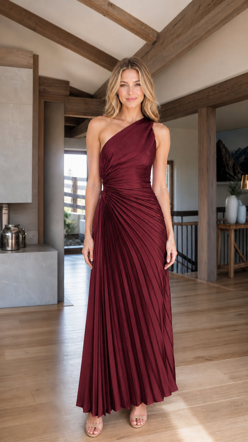 Woman wearing burgundy one-shoulder pleated maxi evening dress