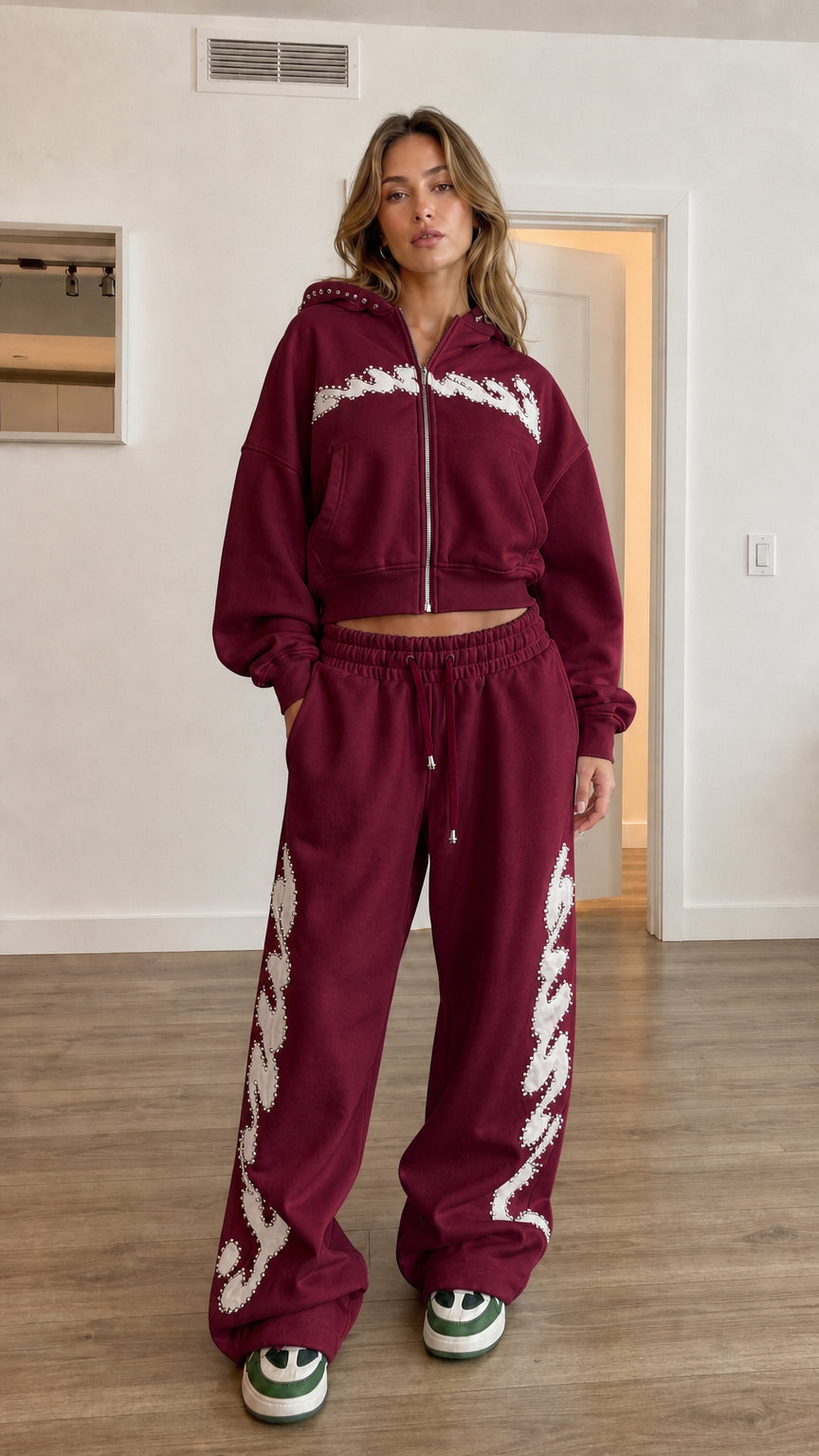 Model wearing burgundy cropped hoodie and wide leg sweatpants set