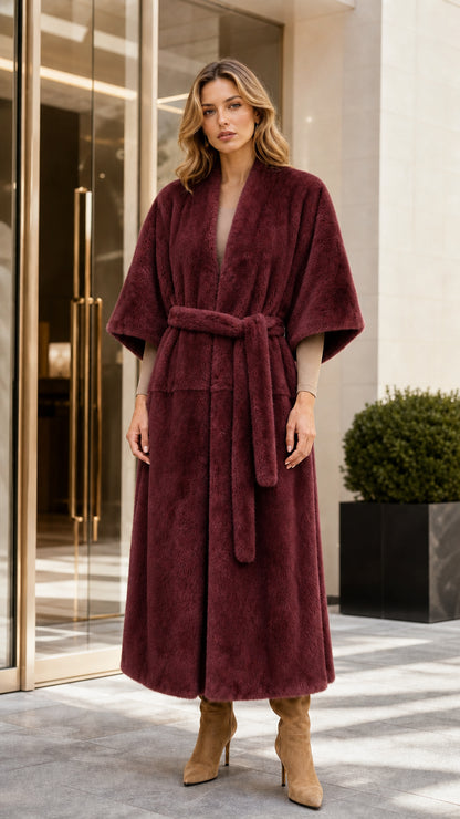 Front view of woman wearing long burgundy faux fur coat