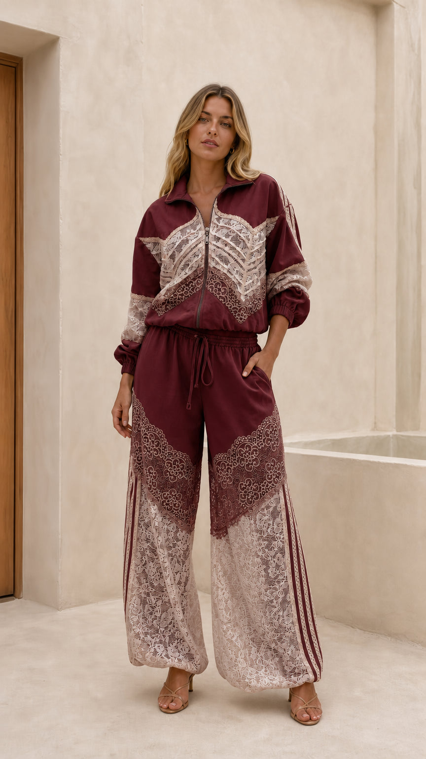 Front view of woman wearing burgundy lace patchwork track set