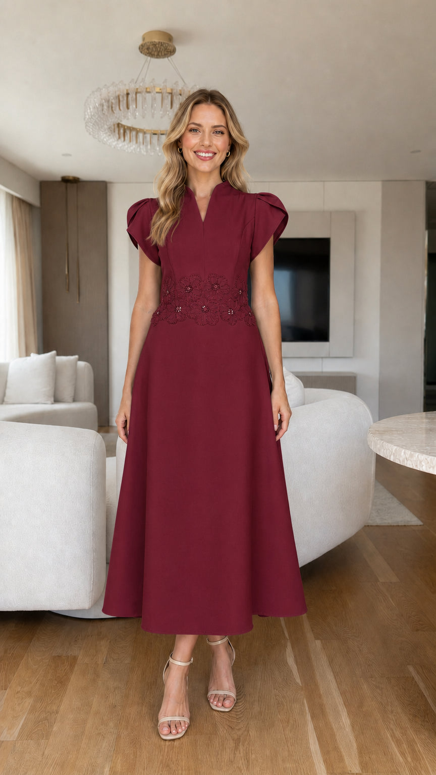 Front view of burgundy red tulip sleeve A-line midi dress with beaded waist