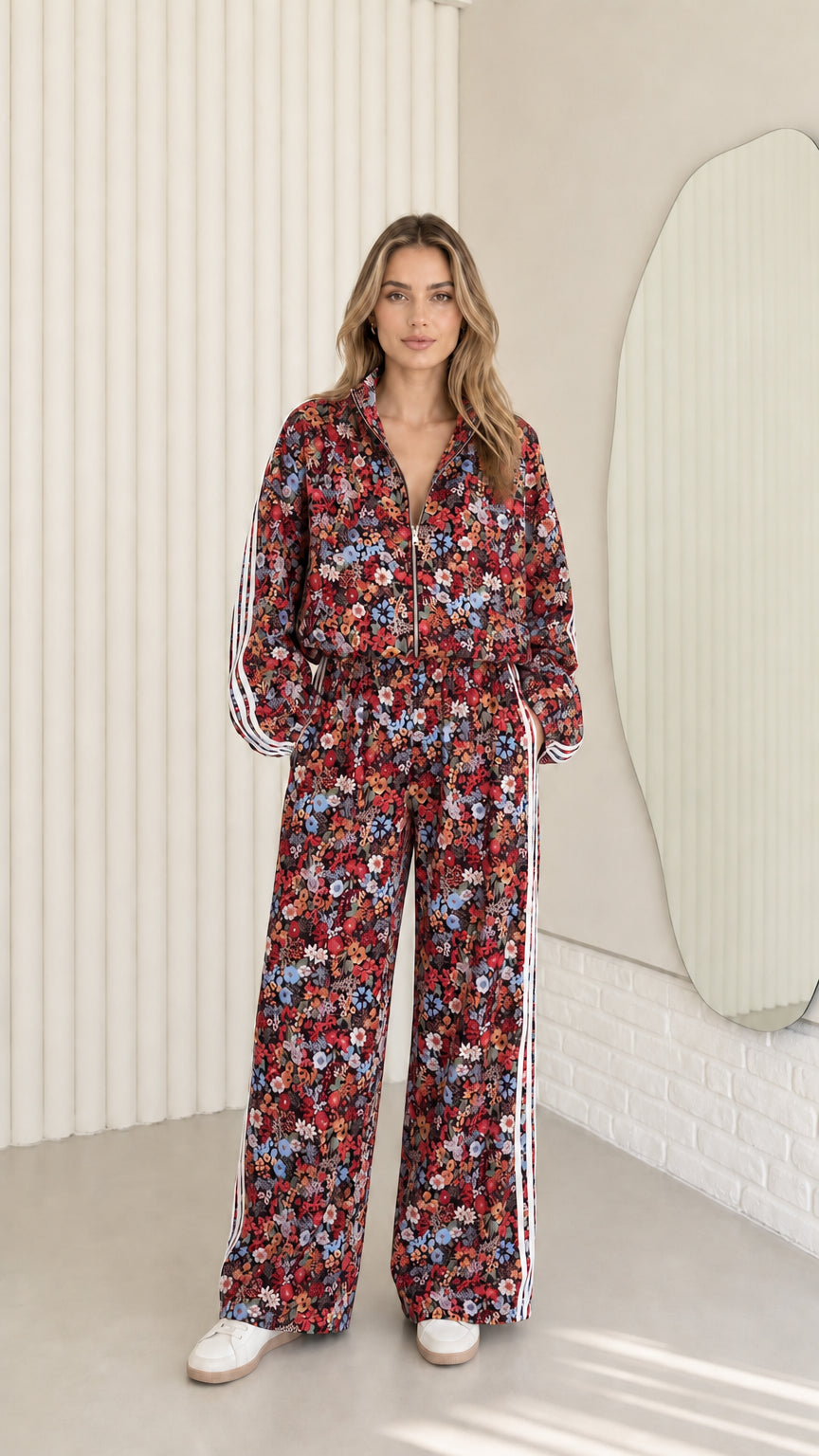 Woman wearing burgundy floral print zip-up tracksuit two-piece set