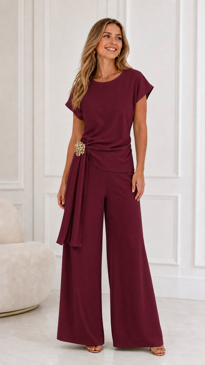 Front view of woman wearing burgundy top and wide-leg pants set