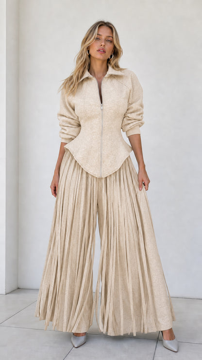 Model wearing neutral beige oatmeal colored two-piece pleated pant set