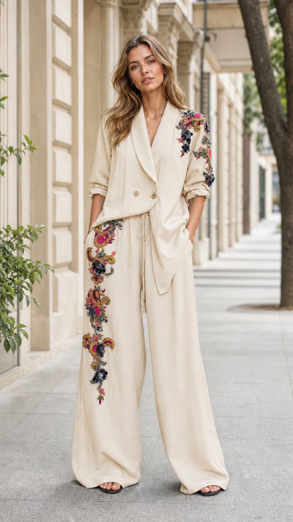 Front view of woman wearing beige embroidered blazer and wide-leg pants set