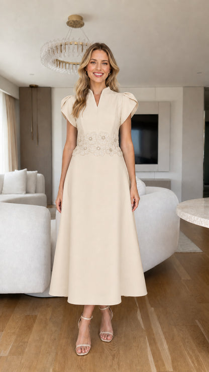 Front view of cream beige tulip sleeve A-line midi dress with beaded waist