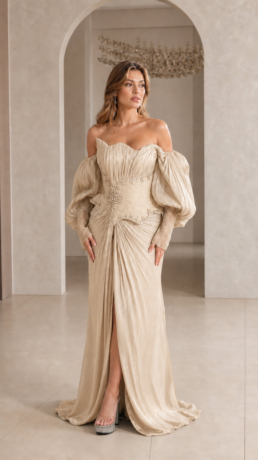 Model wearing Champagne gold pleated formal evening gown with embellished waist