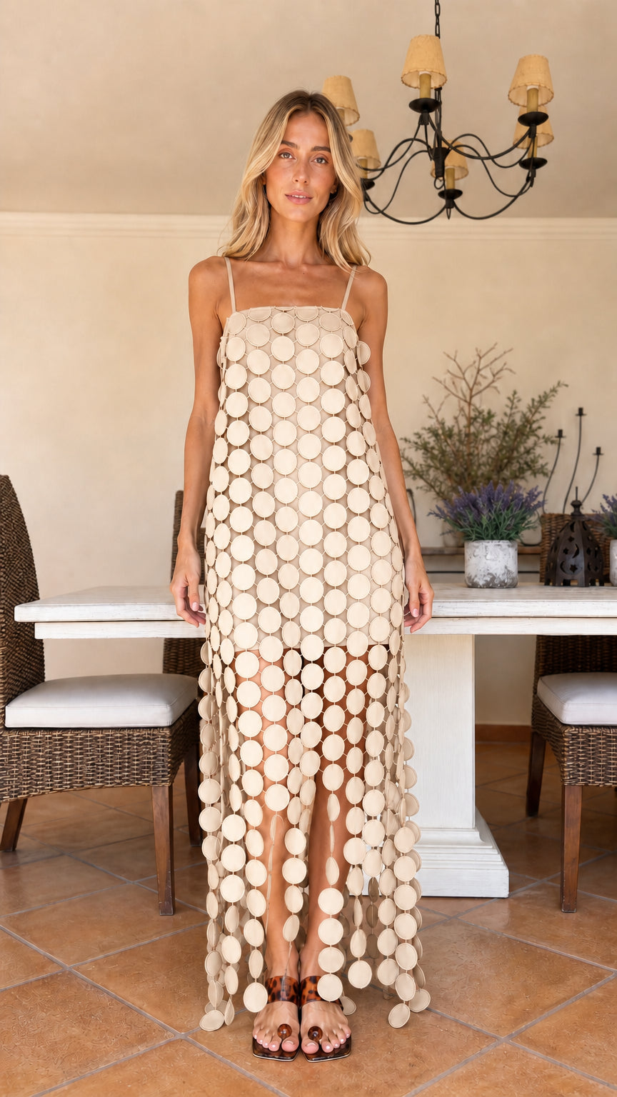 Front view of woman wearing beige cream circle cutout maxi dress