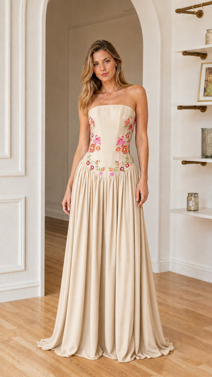 Front view of woman wearing champagne floral embroidered maxi dress