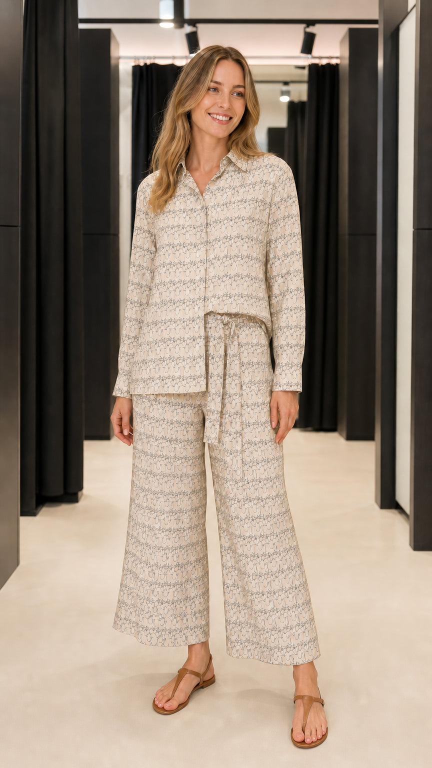 Woman wearing beige geometric print matching shirt and trousers set